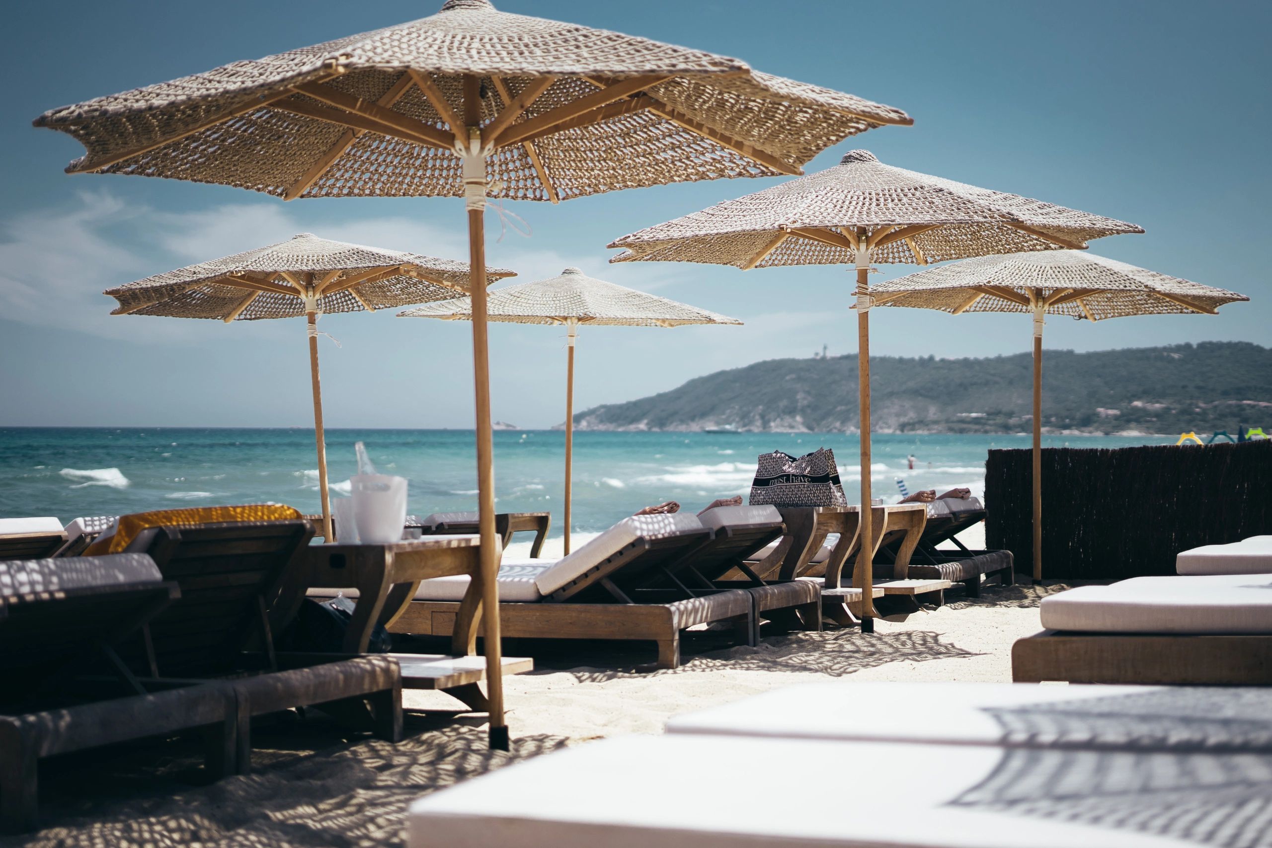 Luxury beach loungers and parasols at an upscale seaside destination
