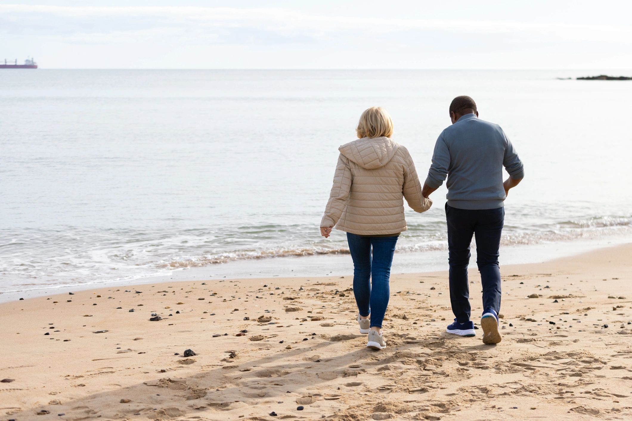 Couple on beach representing honeymoon travel testimonial
